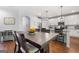 Open dining area showcasing hardwood floors, modern decor, and easy access to the kitchen at 8 Saint Charles Ave, Sharpsburg, GA 30277