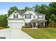 Charming two-story home with a well-manicured lawn, two car garage and tasteful landscaping at 8 Saint Charles Ave, Sharpsburg, GA 30277