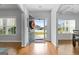 Bright foyer with hardwood floors, a view of the lawn, and a glimpse into the dining room at 8 Saint Charles Ave, Sharpsburg, GA 30277