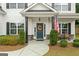 Inviting front porch with an American flag and decorative wreath on a navy blue door at 8 Saint Charles Ave, Sharpsburg, GA 30277