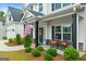 Inviting front porch with seating, decorative wreath, and an American flag by the door at 8 Saint Charles Ave, Sharpsburg, GA 30277
