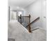 Well-lit hallway with neutral tones and stylish railing creates a welcoming and seamless transition between rooms at 8 Saint Charles Ave, Sharpsburg, GA 30277
