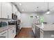 Updated kitchen featuring white cabinets, granite countertops, and stainless steel appliances at 8 Saint Charles Ave, Sharpsburg, GA 30277