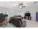 Cozy living room with ceiling fan, two sofas, computer desk and an entertainment center at 8 Saint Charles Ave, Sharpsburg, GA 30277