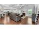 Open-concept living space with hardwood floors, a fireplace, and a view into the kitchen at 8 Saint Charles Ave, Sharpsburg, GA 30277