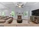 Inviting living room featuring a cozy fireplace, coffered ceilings, and gleaming hardwood floors at 8 Saint Charles Ave, Sharpsburg, GA 30277