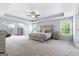 Spacious main bedroom with neutral walls, a ceiling fan and large windows for natural light and fresh air at 8 Saint Charles Ave, Sharpsburg, GA 30277