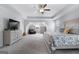 Spacious main bedroom with neutral walls, a ceiling fan and large windows for natural light and fresh air at 8 Saint Charles Ave, Sharpsburg, GA 30277