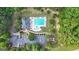 Overhead shot of a refreshing community pool, playground and parking lot surrounded by lush trees at 8 Saint Charles Ave, Sharpsburg, GA 30277