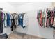 Walk-in closet with hanging rods and carpeted flooring for storage at 8 Saint Charles Ave, Sharpsburg, GA 30277