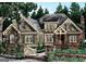 Charming two-story home with lush landscaping and brick details at 2039 Fischer Rd, Sharpsburg, GA 30277