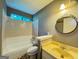 Bathroom featuring a shower-tub combination and a sink with a beige countertop at 8846 Wesley Pl, Jonesboro, GA 30238