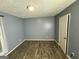 A room with gray walls and dark floors, with a door and window at 8846 Wesley Pl, Jonesboro, GA 30238