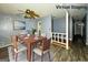 Virtually staged dining room with a dining table and chairs set on a soft rug at 8846 Wesley Pl, Jonesboro, GA 30238