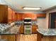 Well-appointed kitchen with granite countertops, stainless steel appliances, and wood cabinetry at 8846 Wesley Pl, Jonesboro, GA 30238