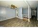 Open living area with wood-look floors, ceiling fan, and clear sightlines through the home at 8846 Wesley Pl, Jonesboro, GA 30238