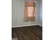 Bedroom featuring dark wood floors and beige curtains hanging over a window at 953 South Ave, Forest Park, GA 30297