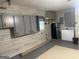 Basement area with cabinets, refrigerator, and epoxy floors, offering versatility and functionality at 6884 Shangrila Way, Riverdale, GA 30296