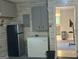 View of the basement with fridge, cabinets and access to another room, for extra kitchen or storage space at 6884 Shangrila Way, Riverdale, GA 30296