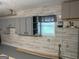 View of the basement area showing cabinets, a small window, and essential utility connections at 6884 Shangrila Way, Riverdale, GA 30296