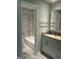 Bathroom featuring a granite vanity, white cabinets, and shower at 6884 Shangrila Way, Riverdale, GA 30296