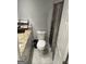 Bathroom featuring toilet, shower curtain, and granite vanity at 6884 Shangrila Way, Riverdale, GA 30296