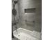 Modern bathroom with gray tile, tub, shower, and safety grab bars at 6884 Shangrila Way, Riverdale, GA 30296