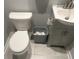 Neat half-bathroom featuring a toilet, sink with vanity, and essential fixtures for guest convenience at 6884 Shangrila Way, Riverdale, GA 30296