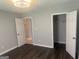 Bedroom with hardwood flooring, closet and entry door at 6884 Shangrila Way, Riverdale, GA 30296