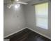 Bedroom with ceiling fan, natural light from window and hardwood flooring at 6884 Shangrila Way, Riverdale, GA 30296
