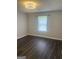 Bedroom with modern ceiling light and hardwood flooring at 6884 Shangrila Way, Riverdale, GA 30296