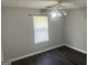 Bright bedroom featuring a ceiling fan and modern hardwood floors at 6884 Shangrila Way, Riverdale, GA 30296