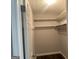 Bright walk-in closet with shelving and dark hardwood floors at 6884 Shangrila Way, Riverdale, GA 30296