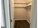 Spacious walk-in closet with installed shelving and dark wood floors at 6884 Shangrila Way, Riverdale, GA 30296