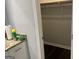 Walk-in closet with white cabinets and dark wood floors at 6884 Shangrila Way, Riverdale, GA 30296