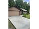 Well-maintained home with a concrete driveway, green lawn, and tasteful landscaping at 6884 Shangrila Way, Riverdale, GA 30296