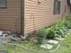 Exterior of home features garden area with walkway along siding at 6884 Shangrila Way, Riverdale, GA 30296