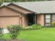 Charming single-story home featuring a front yard, attached garage, and covered porch perfect for relaxing at 6884 Shangrila Way, Riverdale, GA 30296
