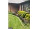 Well-manicured lawn with decorative plants, adding charm and curb appeal to this home's exterior at 6884 Shangrila Way, Riverdale, GA 30296