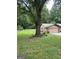 Expansive front lawn featuring mature tree, and landscaping, showcasing the home's serene outdoor setting at 6884 Shangrila Way, Riverdale, GA 30296