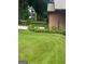Green lawn and vibrant landscaping enhance the home's front yard, creating a welcoming and picturesque scene at 6884 Shangrila Way, Riverdale, GA 30296