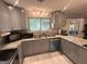 Functional kitchen featuring gray cabinets, stainless steel appliances, and granite countertops at 6884 Shangrila Way, Riverdale, GA 30296