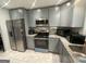 Updated kitchen featuring stainless steel appliances, granite countertops, and ample cabinet space at 6884 Shangrila Way, Riverdale, GA 30296