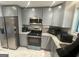 Well-equipped kitchen features stainless steel appliances, gray cabinets, and granite countertops at 6884 Shangrila Way, Riverdale, GA 30296