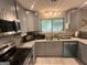 Well-lit kitchen showcasing granite countertops, stainless appliances, and tile flooring at 6884 Shangrila Way, Riverdale, GA 30296