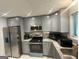 Updated kitchen featuring stainless steel appliances, granite countertops, and ample cabinet space at 6884 Shangrila Way, Riverdale, GA 30296