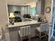 Open kitchen featuring bar seating, stainless steel appliances, and great lighting at 6884 Shangrila Way, Riverdale, GA 30296