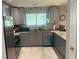 Modern kitchen with gray cabinets, granite countertops, stainless steel appliances, and tile flooring at 6884 Shangrila Way, Riverdale, GA 30296