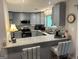 Spacious kitchen with breakfast bar, granite countertops, and modern stainless steel appliances at 6884 Shangrila Way, Riverdale, GA 30296