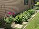 Beautiful landscaping featuring colorful flowers and lush greenery along the side of the home at 6884 Shangrila Way, Riverdale, GA 30296